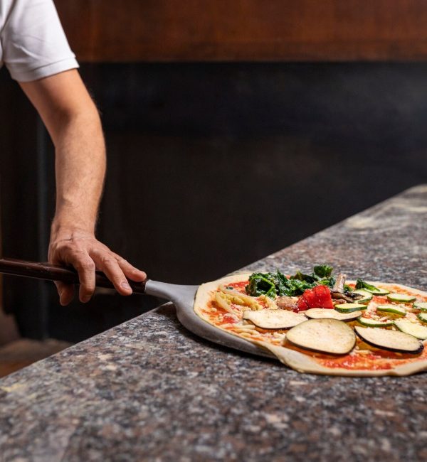 front-view-chef-preparing-pizza_23-2150235789