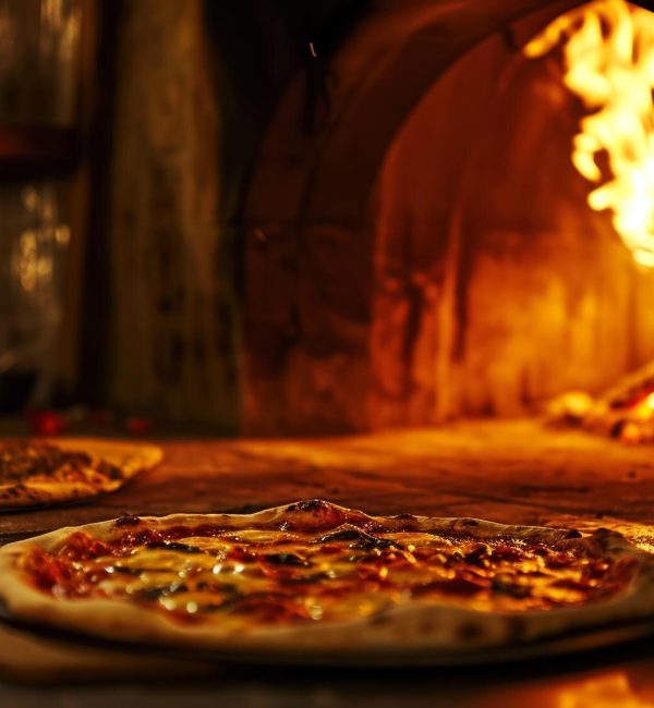 two-freshly-baked-pizzas-by-woodburning-oven-pizza-cooking-old-cafe-traditional_166373-6615